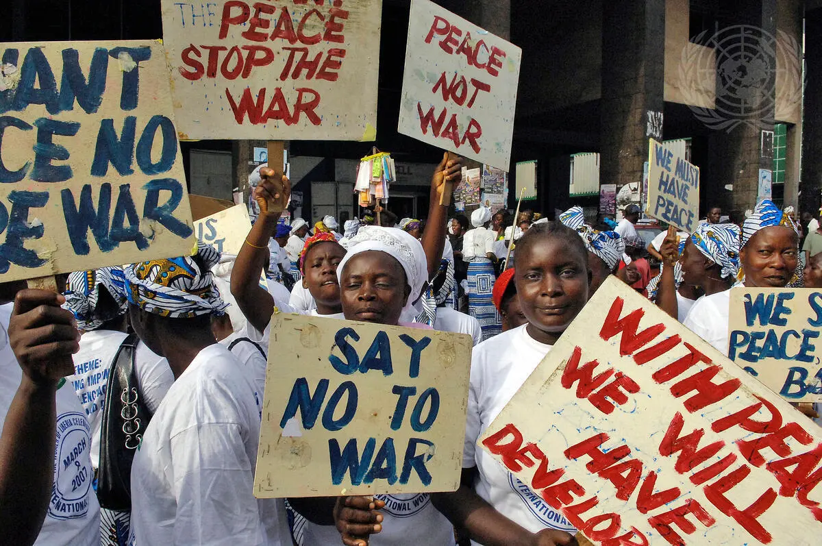 In observance of International Women's Day, participants march from the centre of Monrovia to the Temple of Justice, home of the Liberian Supreme Court, where they staged a peaceful sit-in protest against gender-based violence. Photo: UN Photo/Eric Kanalstein